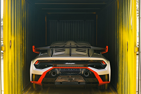 Supercar loaded into secure enclosed vehicle transporter
