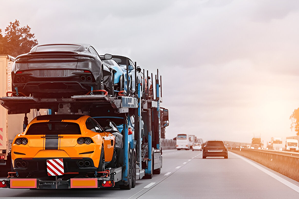 Fleet of enclosed carriers transporting performance cars